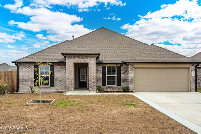 view of front facade featuring a garage and a front lawn