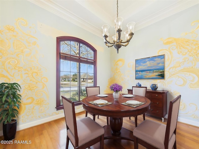 dining space with a chandelier, crown molding, light wood-style floors, and baseboards