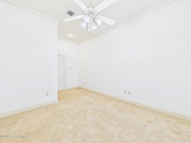 unfurnished room with visible vents, crown molding, baseboards, light colored carpet, and ceiling fan