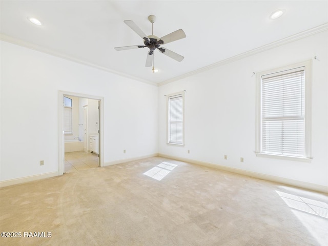 unfurnished room with light carpet, a ceiling fan, crown molding, and baseboards