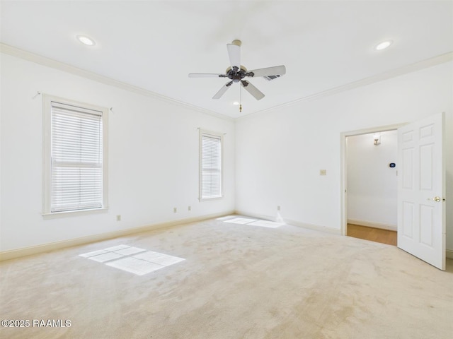 carpeted spare room with a ceiling fan, crown molding, recessed lighting, and baseboards