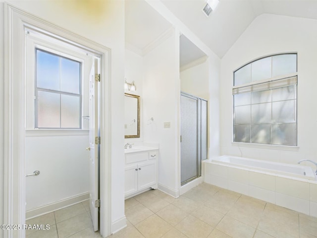 full bathroom featuring a garden tub, a shower stall, tile patterned flooring, lofted ceiling, and vanity