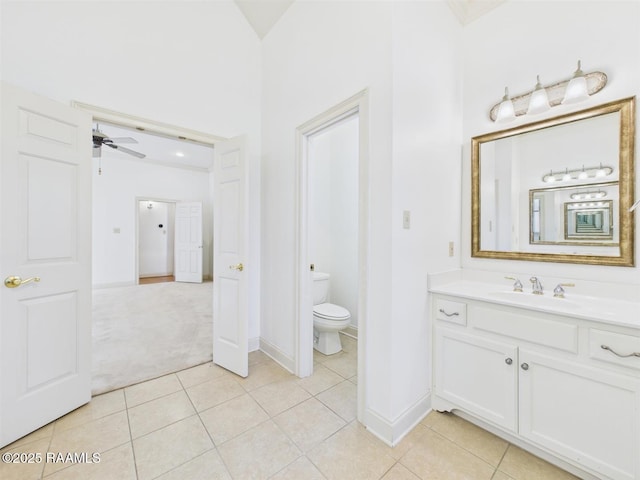 bathroom with vanity, tile patterned floors, toilet, and a ceiling fan