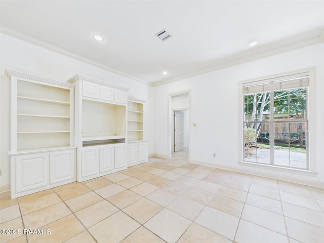 spare room featuring light tile patterned floors, visible vents, baseboards, and ornamental molding