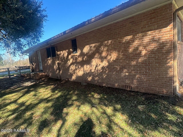 view of side of home featuring a lawn