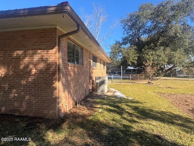 view of property exterior featuring a lawn and central air condition unit