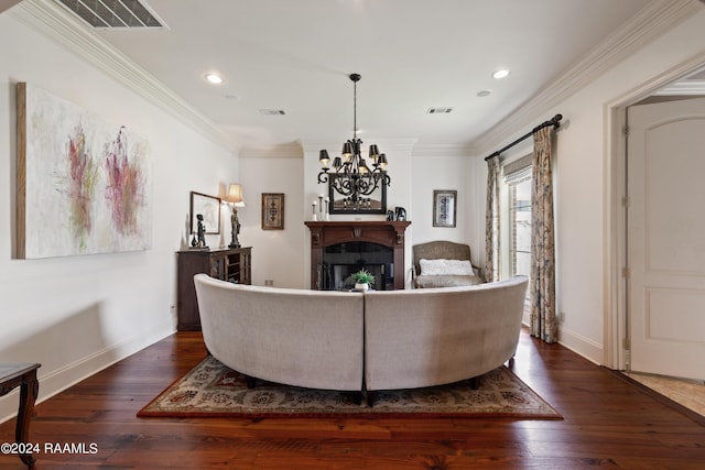 living room featuring crown molding, dark wood-type flooring, and an inviting chandelier