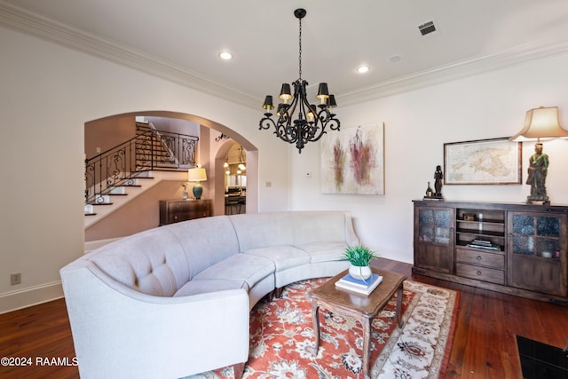 living room with an inviting chandelier, ornamental molding, and dark hardwood / wood-style flooring