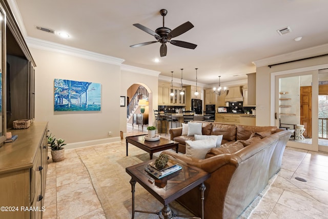 living room featuring crown molding and ceiling fan with notable chandelier