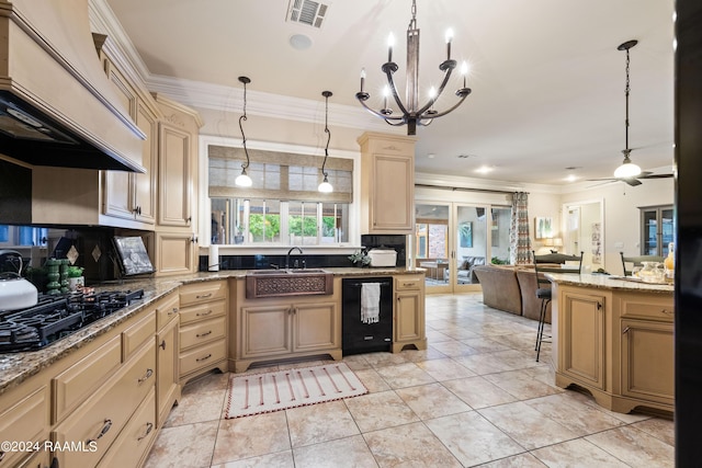 kitchen with pendant lighting, crown molding, and black appliances