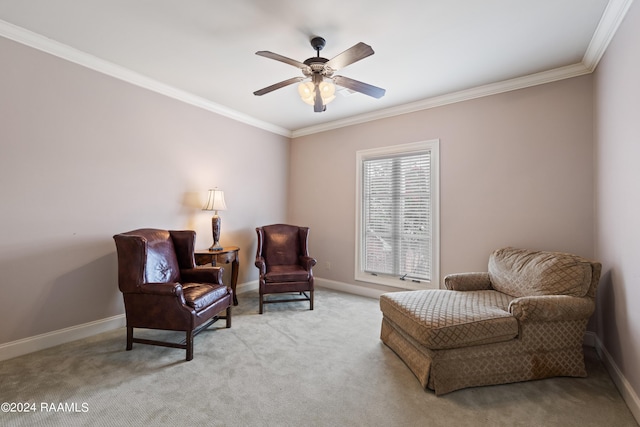 sitting room with ceiling fan, ornamental molding, and light carpet