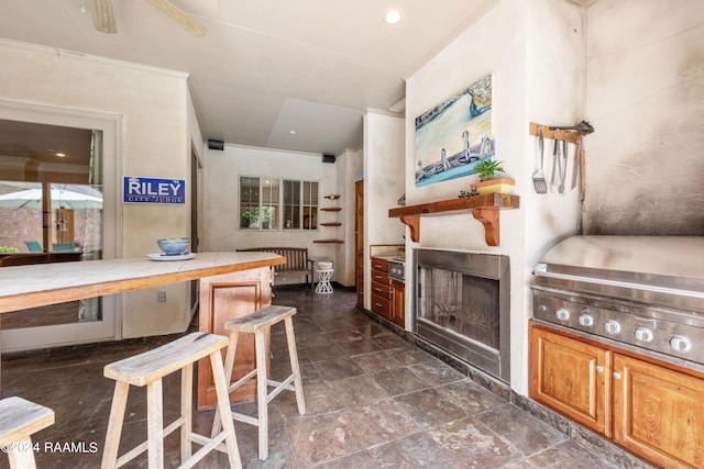 kitchen with ornamental molding and tile counters