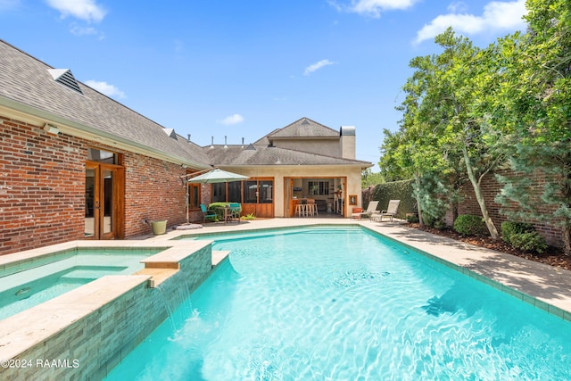 view of swimming pool with a patio area and an in ground hot tub