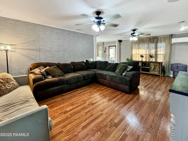 living room with wood-type flooring and a wall mounted air conditioner