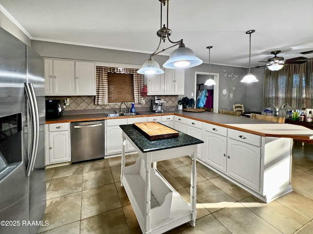 kitchen with sink, white cabinetry, a center island, pendant lighting, and stainless steel appliances