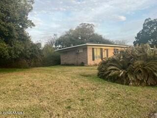 view of home's exterior with a yard