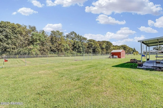 view of yard featuring a rural view and a storage shed