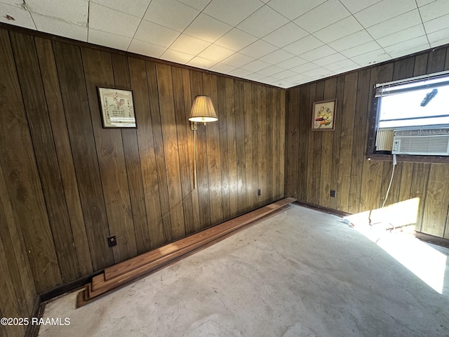 empty room with cooling unit and wood walls