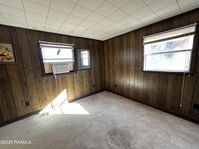 spare room with cooling unit and wooden walls