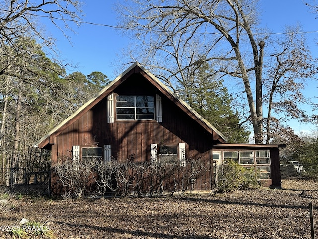 view of property exterior with a sunroom