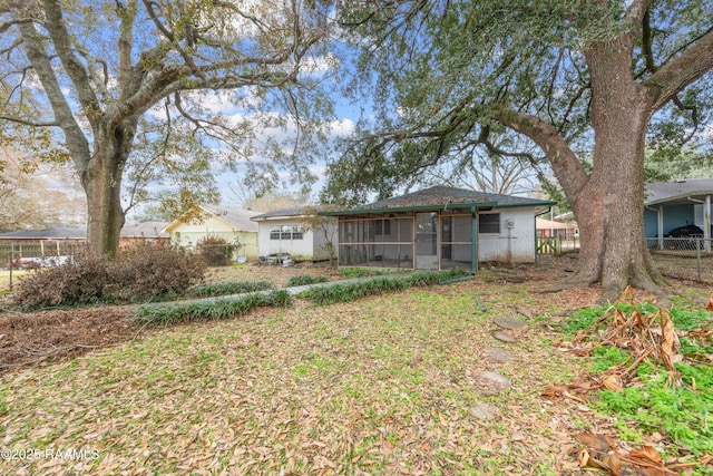 rear view of property with a sunroom