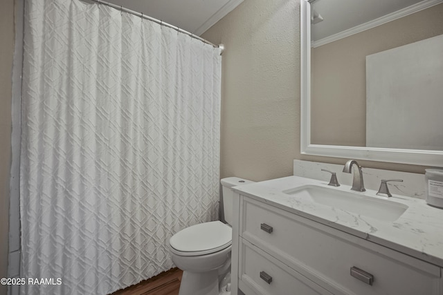 bathroom featuring hardwood / wood-style floors, vanity, toilet, crown molding, and a shower with shower curtain