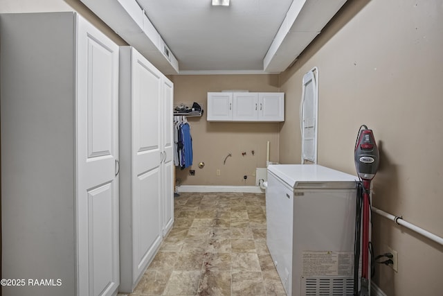 washroom with hookup for a washing machine and cabinets