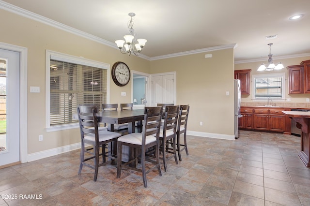 dining room featuring an inviting chandelier, sink, and ornamental molding