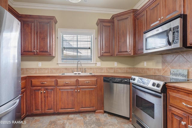 kitchen with sink, crown molding, backsplash, and appliances with stainless steel finishes