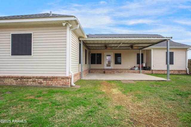 back of property with ceiling fan, a patio, and a lawn