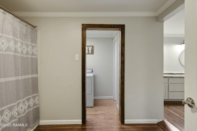 bathroom with crown molding, vanity, washer / dryer, and wood-type flooring