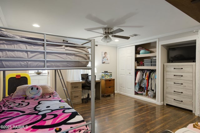 bedroom with ornamental molding, ceiling fan, dark hardwood / wood-style flooring, and a closet