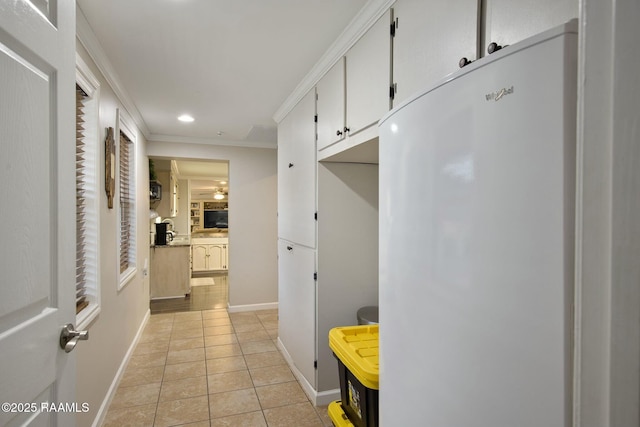 mudroom featuring crown molding and light tile patterned floors