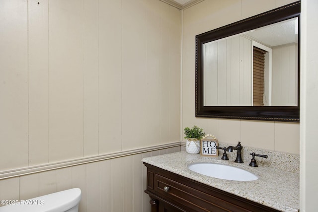 bathroom featuring vanity and toilet