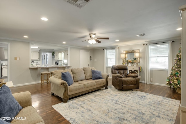 living room featuring crown molding, ceiling fan, and dark hardwood / wood-style floors