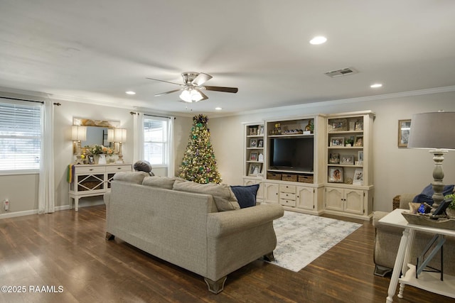 living room featuring dark hardwood / wood-style flooring, ornamental molding, and ceiling fan