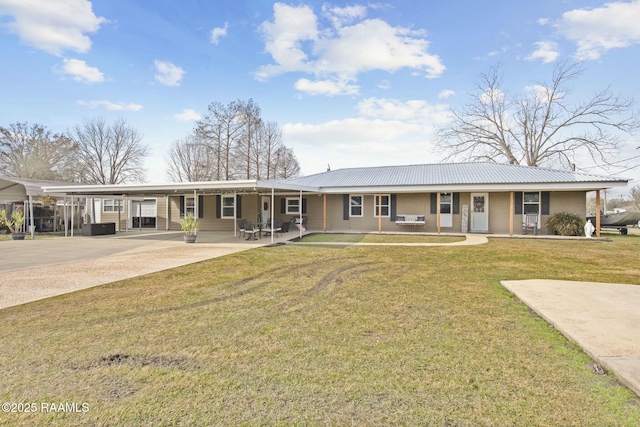 single story home featuring a carport, a front yard, and covered porch