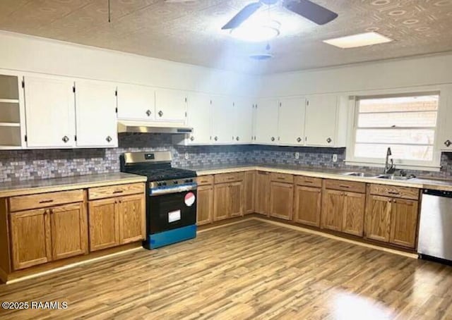 kitchen featuring white cabinetry, sink, stainless steel appliances, and light wood-type flooring