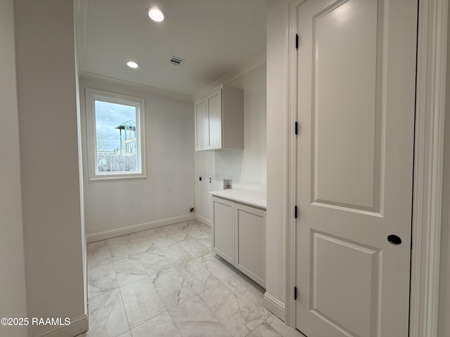 laundry area featuring crown molding, hookup for a washing machine, cabinets, and hookup for an electric dryer