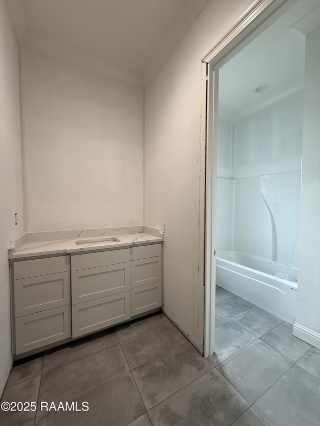 bathroom with tile patterned flooring and vanity