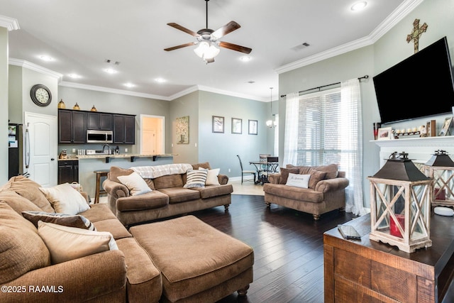 living room featuring crown molding, ceiling fan, and dark hardwood / wood-style flooring