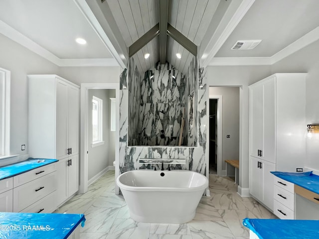 bathroom with vaulted ceiling with beams and a bath