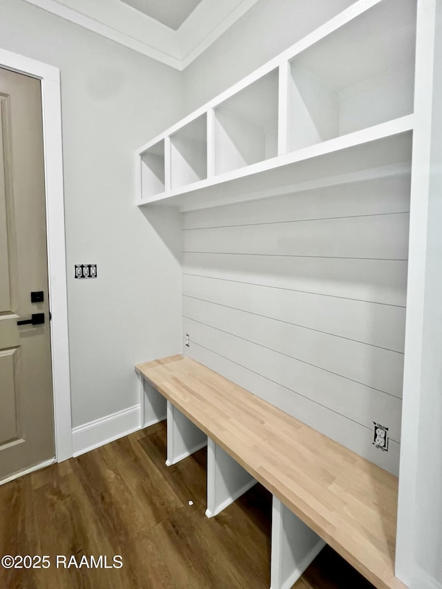 mudroom with dark hardwood / wood-style flooring and crown molding