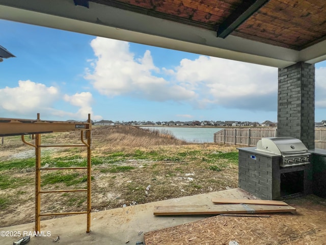 view of yard with a water view and an outdoor kitchen