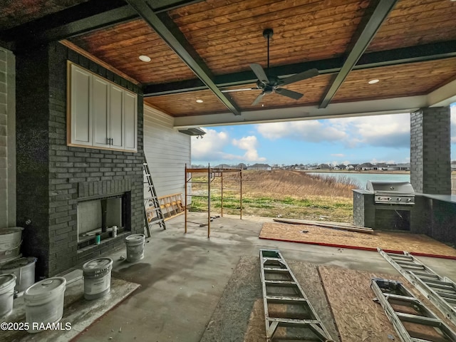 view of patio with area for grilling, a grill, ceiling fan, an outdoor brick fireplace, and a water view