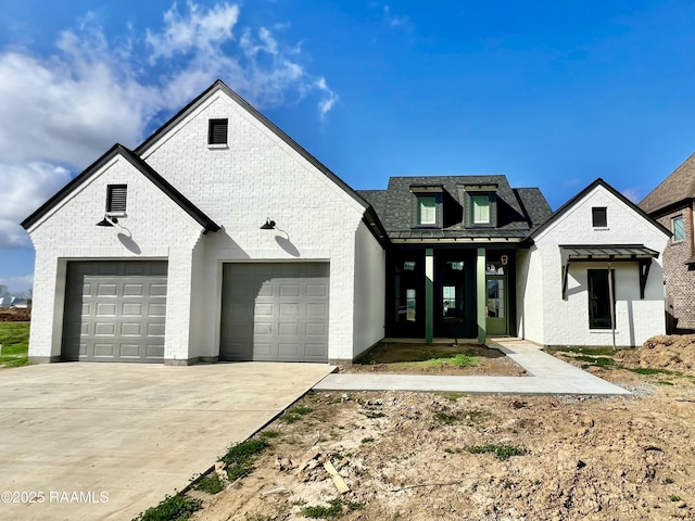 french provincial home featuring a garage