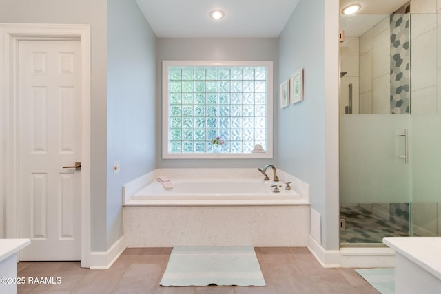 bathroom with tile patterned flooring, vanity, and shower with separate bathtub