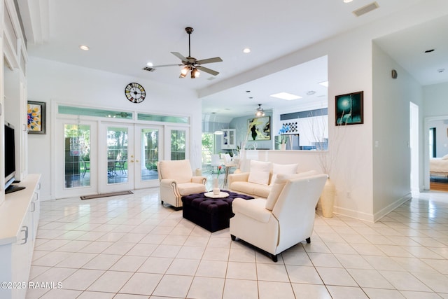 tiled living room with french doors and ceiling fan