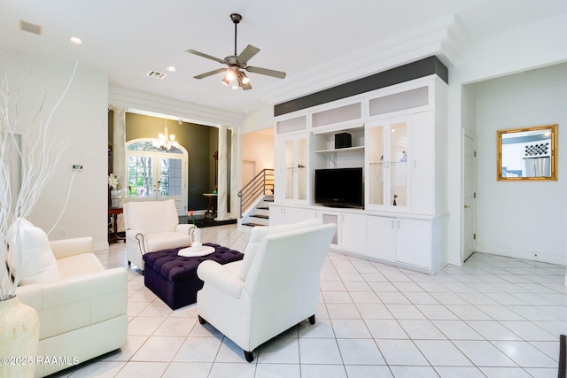 tiled living room with built in shelves, ceiling fan with notable chandelier, and french doors