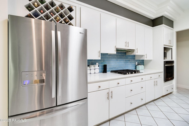 kitchen with white cabinetry, tasteful backsplash, light tile patterned flooring, and appliances with stainless steel finishes